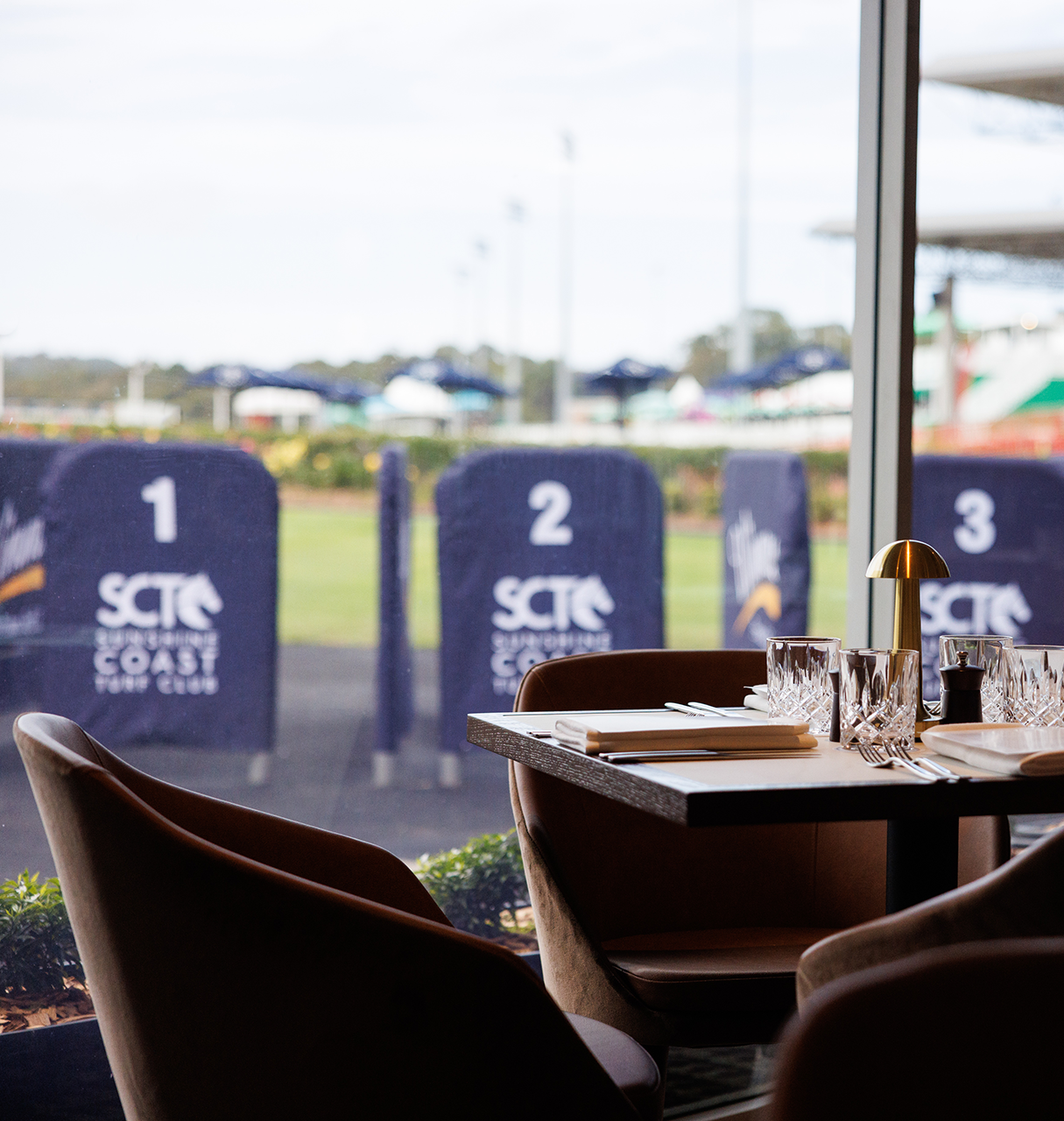 Sunshine Coast Turf Club Chairman's Club dining and hospitality area. Modern furnishings with luxurious table layouts.